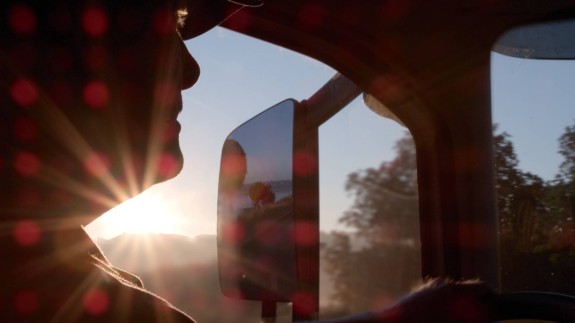 Chauffeur in zijn cabine bij zonsondergang