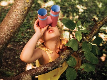 a kid looking through a binacoulars