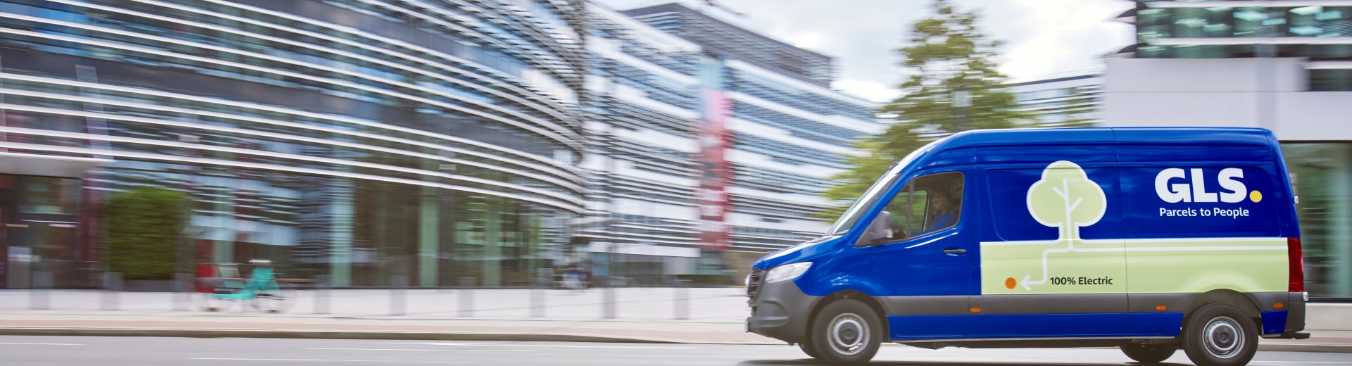 GLS blue-colored 100% electric delivery vehicle is driving on the street