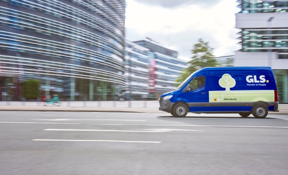 GLS blue-colored 100% electric delivery vehicle is driving on the street