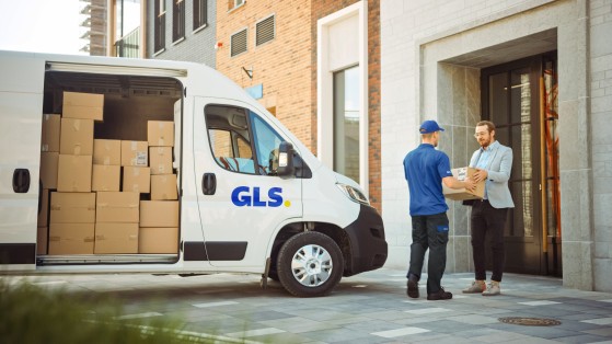 GLS driver pickiing up a package from a customer